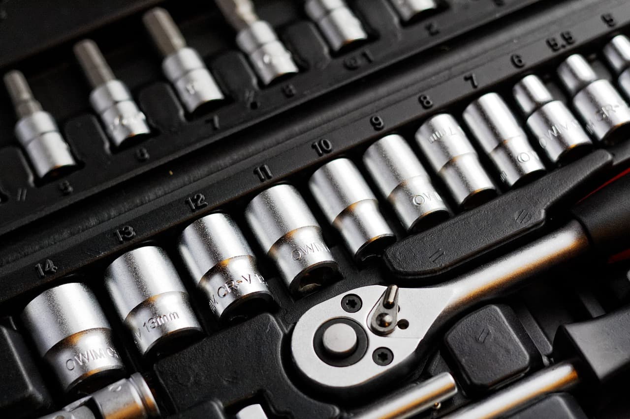 A ratchet and a row of sockets in a tool case