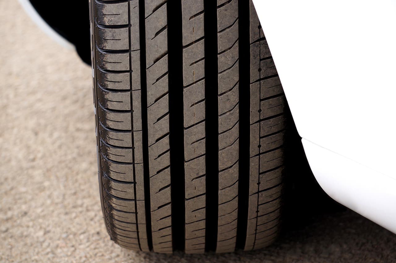 The tread of a front tyre on a white car