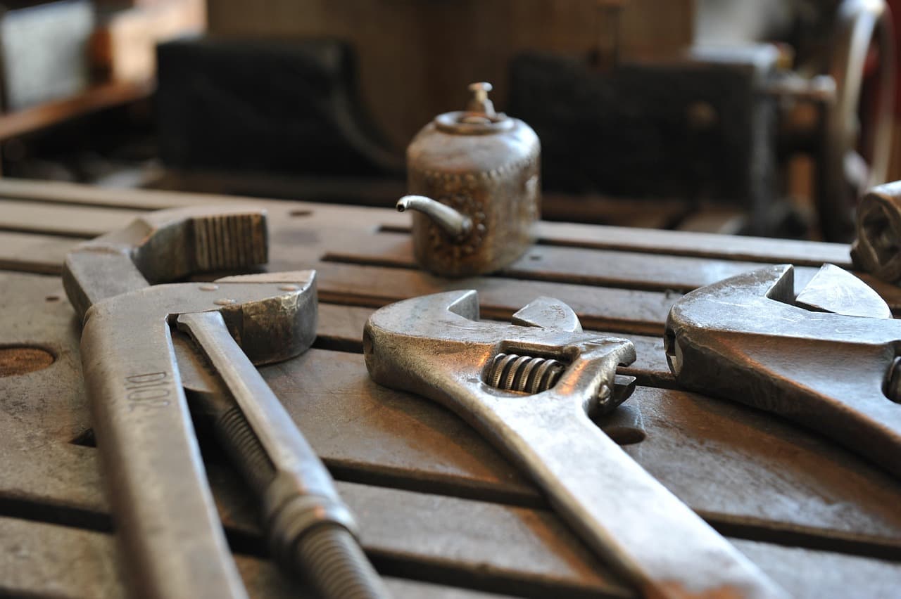 Heavy spanners laid out on a steel workbench