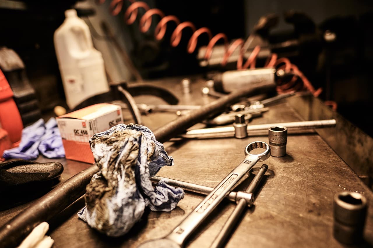 Spanners, sockets and a rag on a workshop bench